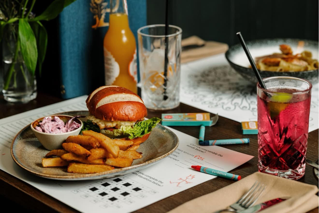 Peacock_Owler_Bar_Kids_Eat_Free Kids eat free at the Peacock at Owler Bar. Burger and chips on a table with children's menu and crayons