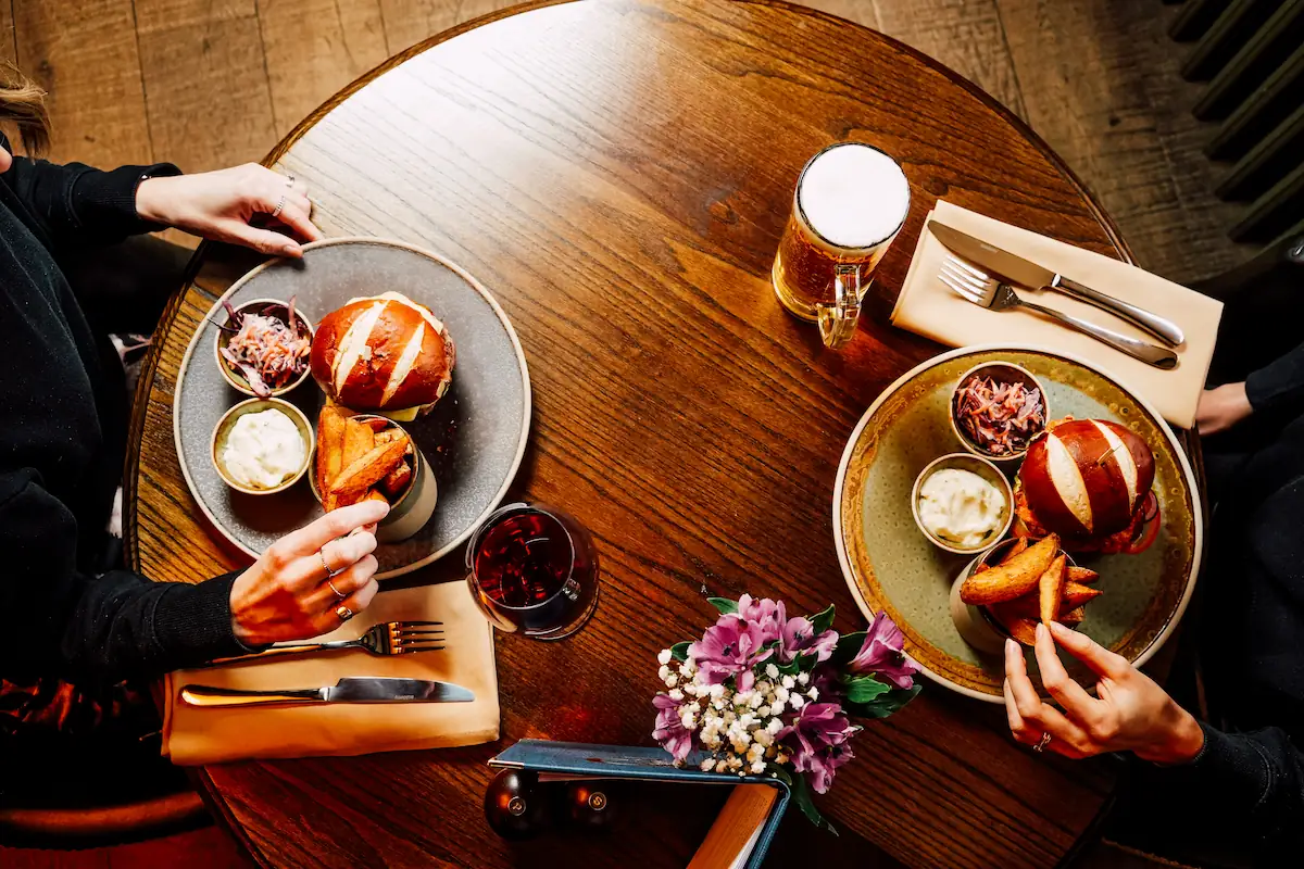 peacock-owler-bar-burgers-table Two burgers on a table at The Peacock at Owler Bar