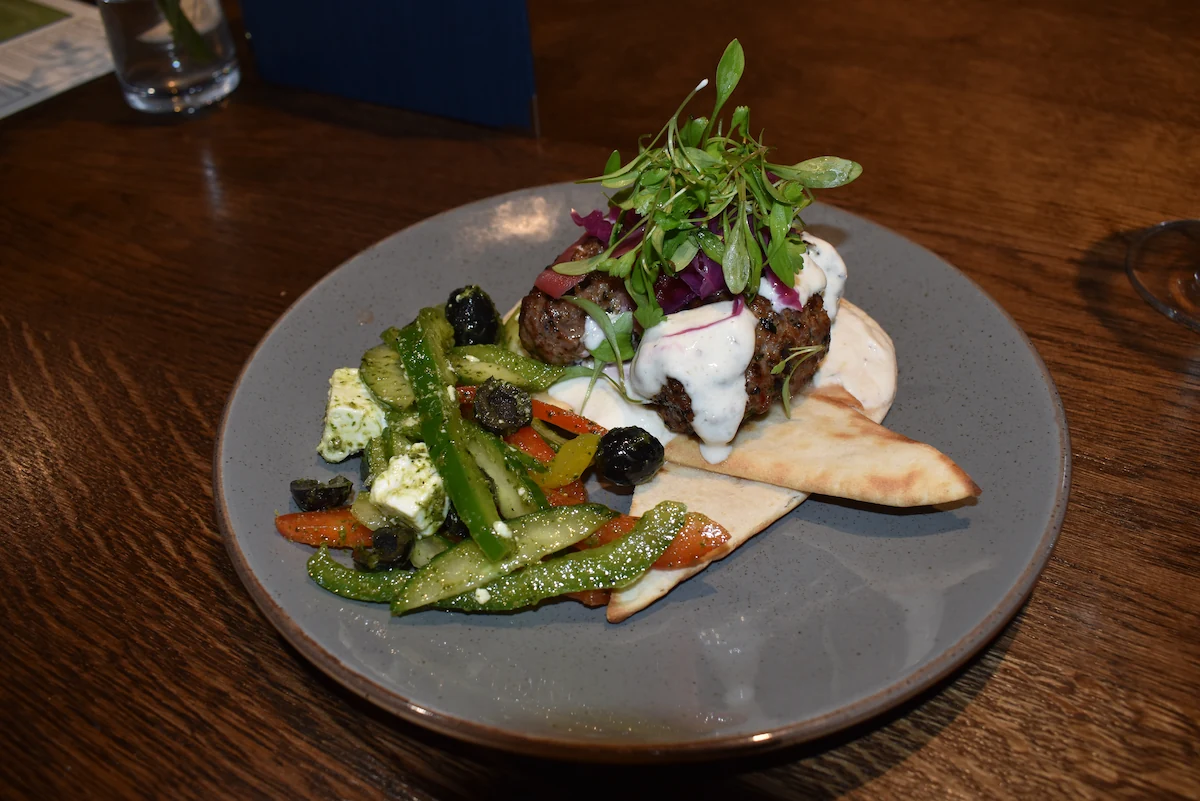 Lamb-Kofta Lamb kofta on grilled pitta bread served with a Greek feta salad (GFa)